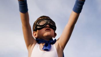 child dressed up as superhero